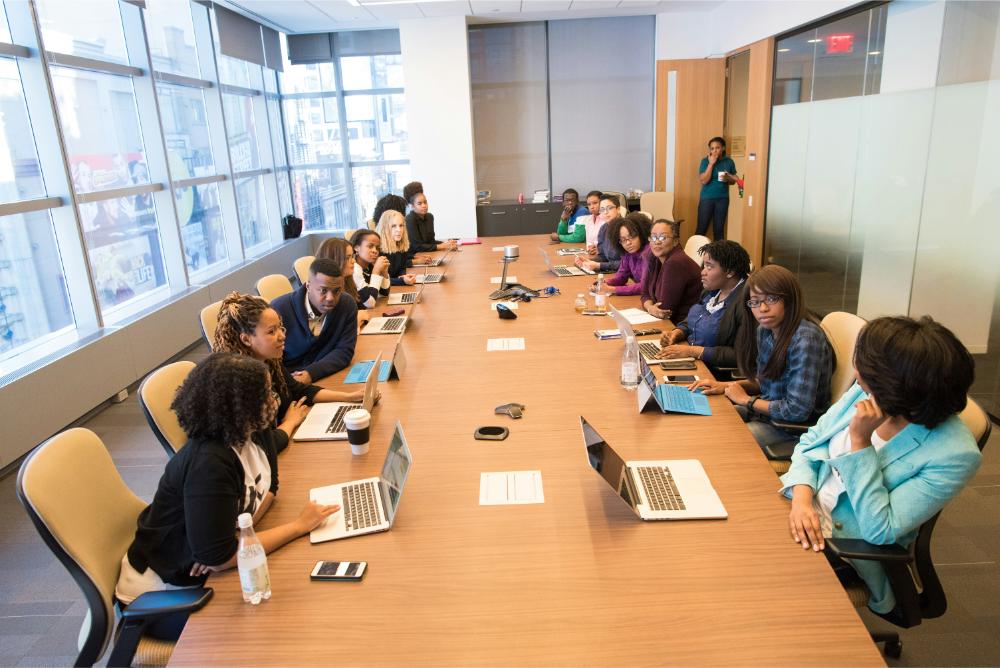 Group of professionals in the meeting room working on their laptops