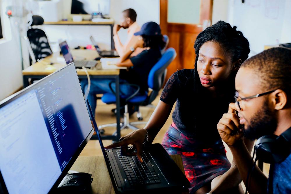 2 young professionals working on a computer