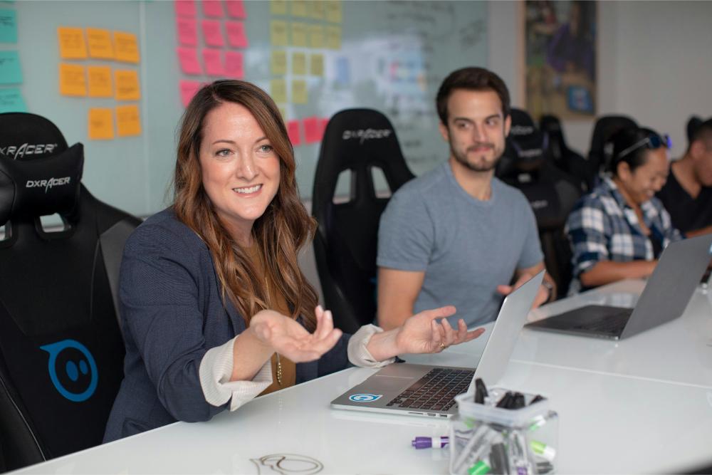 Professionals meeting together while working on their laptops